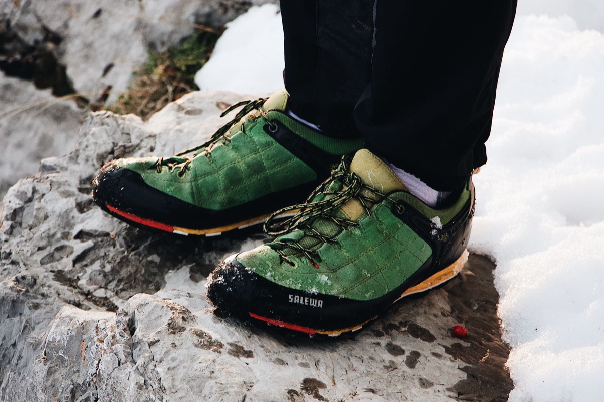 Snowy mountain trail with hiking boots