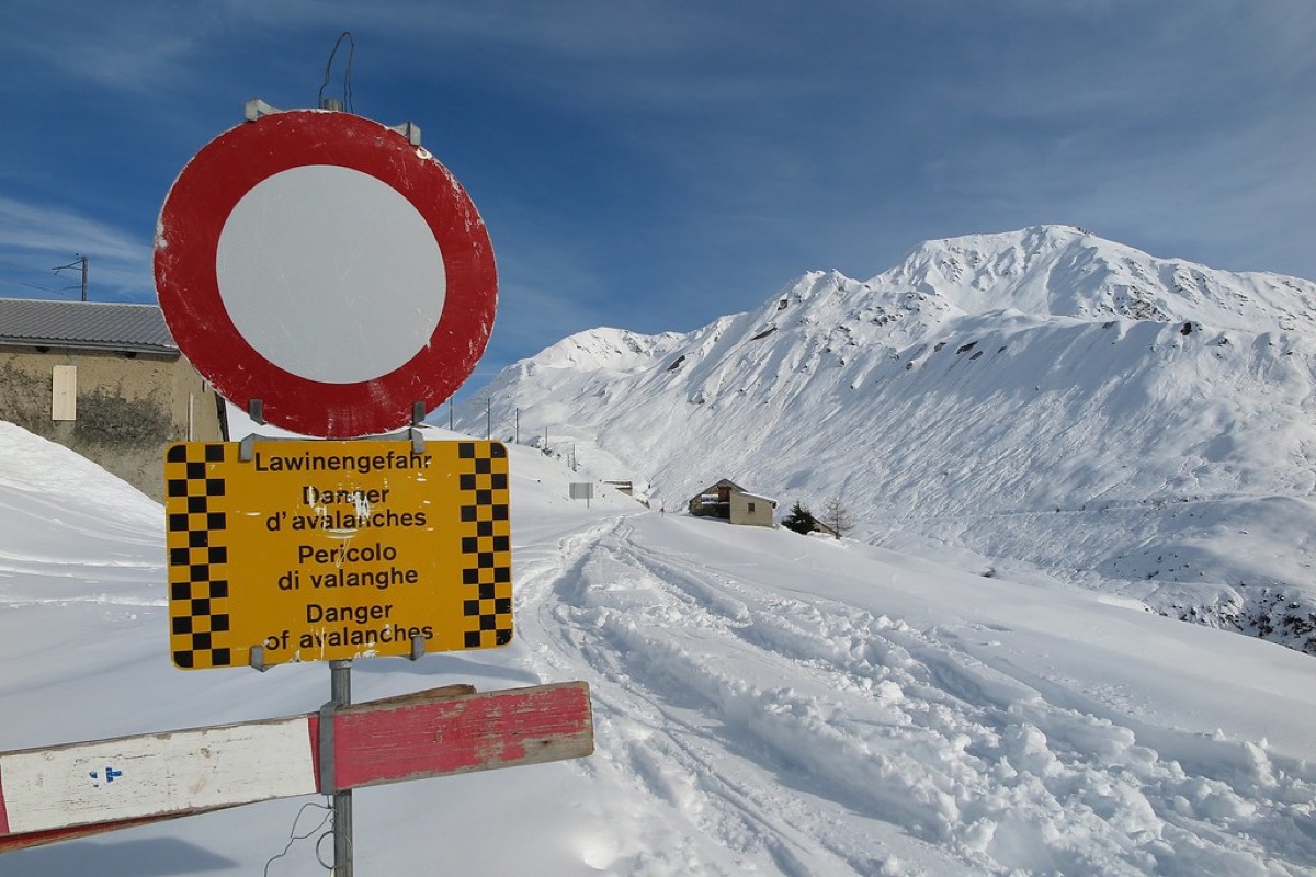 Swiss mountain pass sign with informational plaque