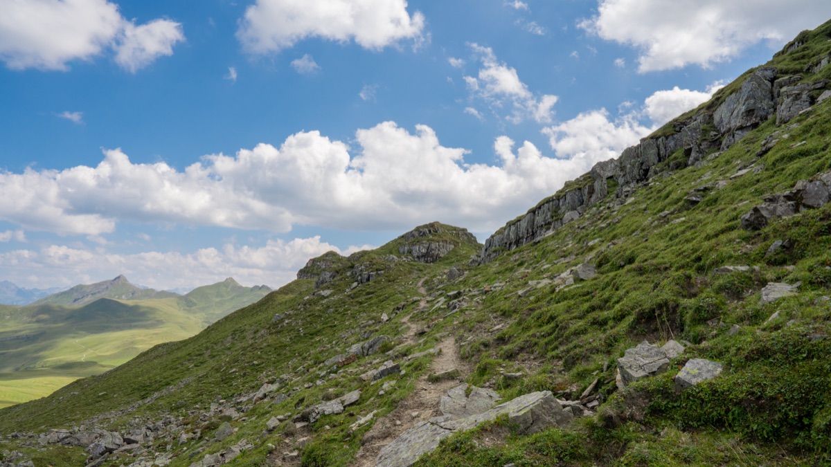 Swiss Alps hiking trail markers with pass information stickers