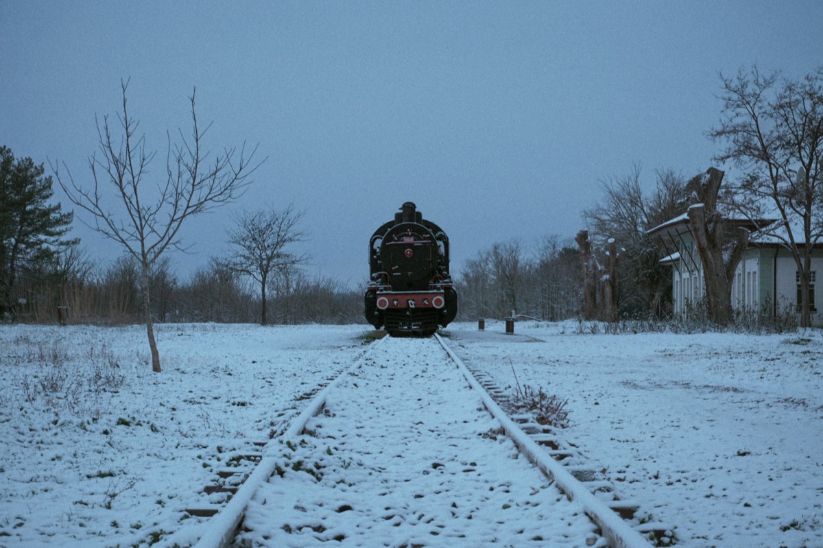 Alpine railway station with snow-covered surroundings