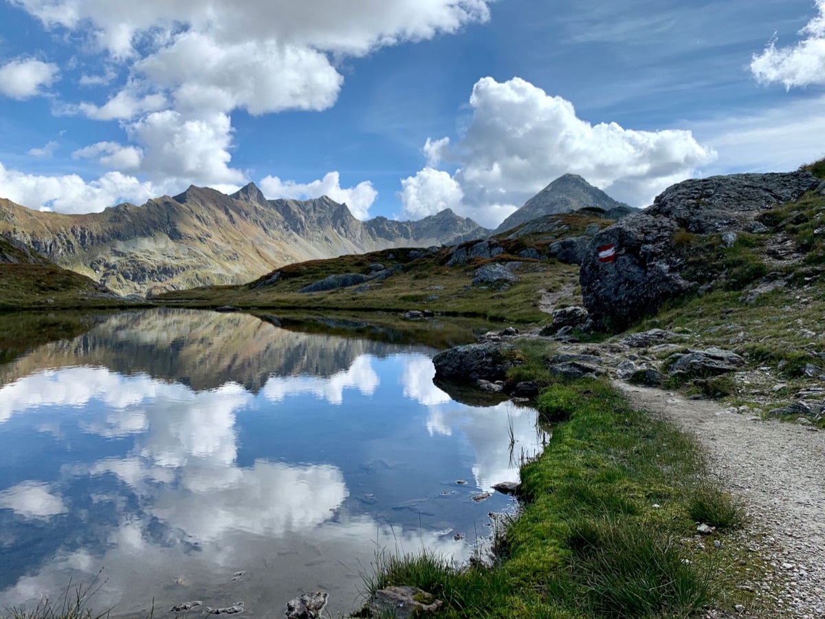 Alpine hiking trail with water bottle