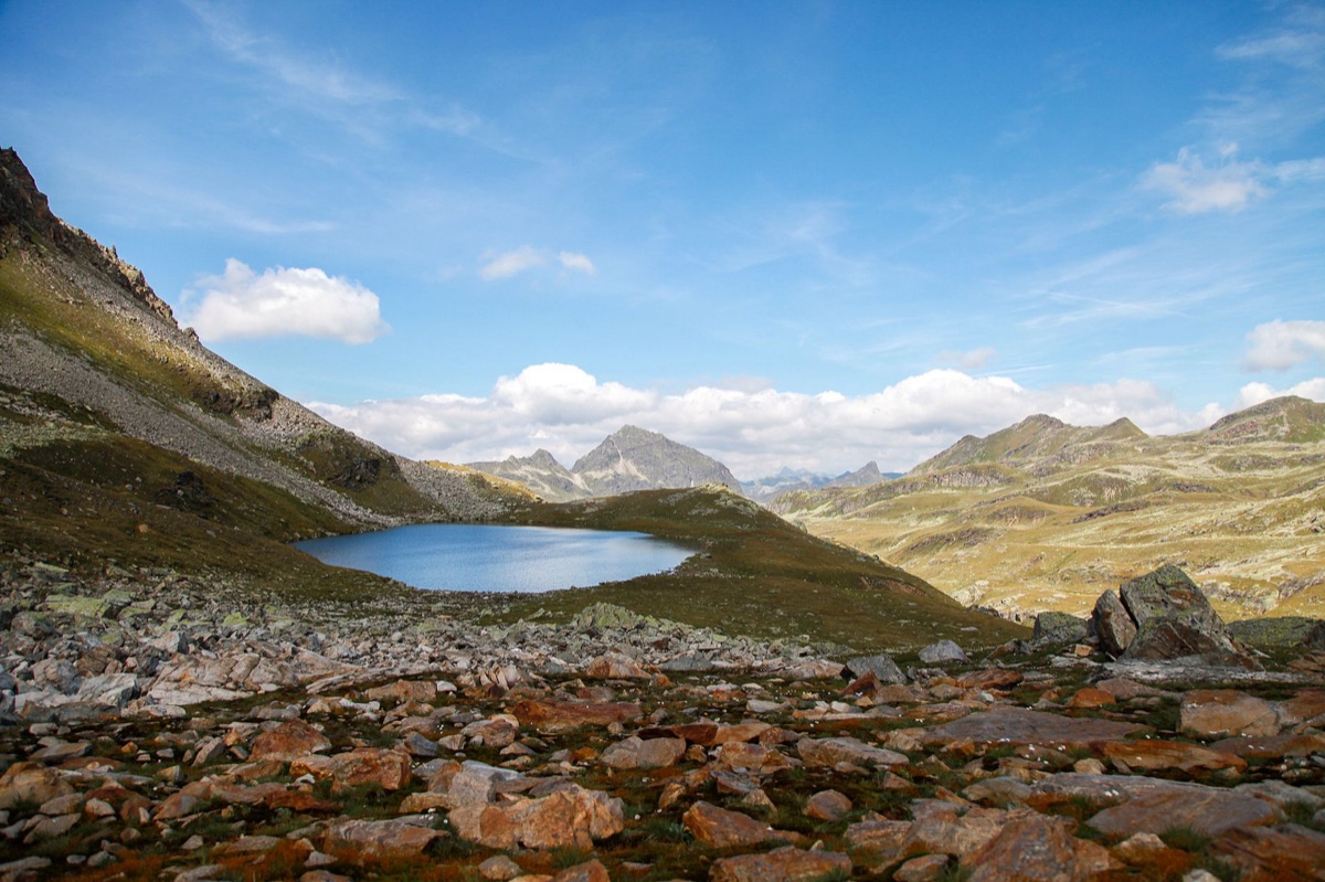 Alpine hiking trail with water bottle and backpack