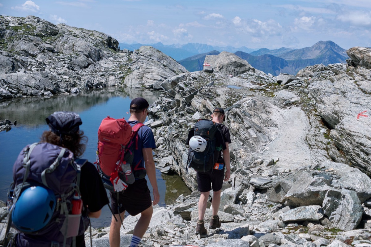 hiker with backpack on alpine path
