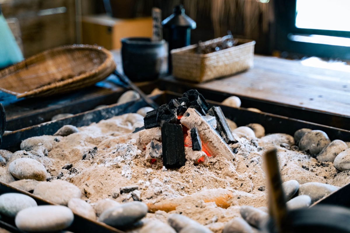 alpine hütte interior with wooden table and stone hearth