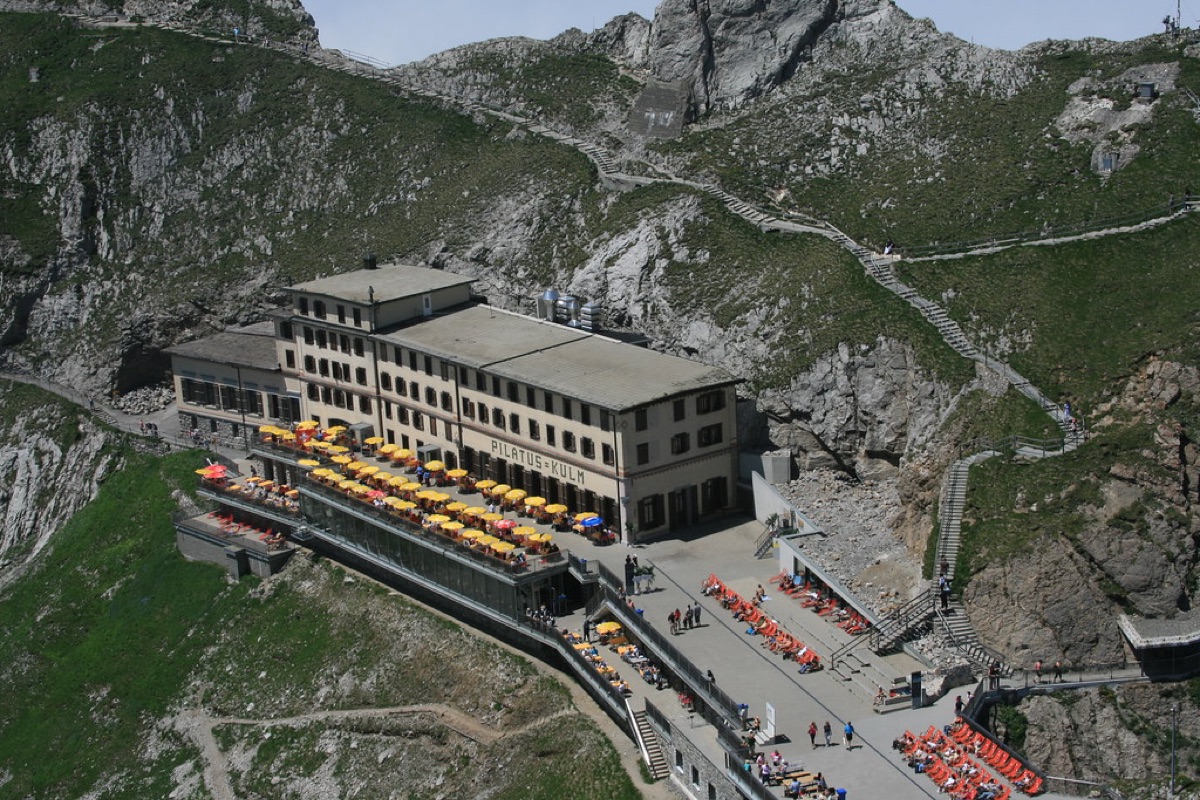 Alpine train station with travelers