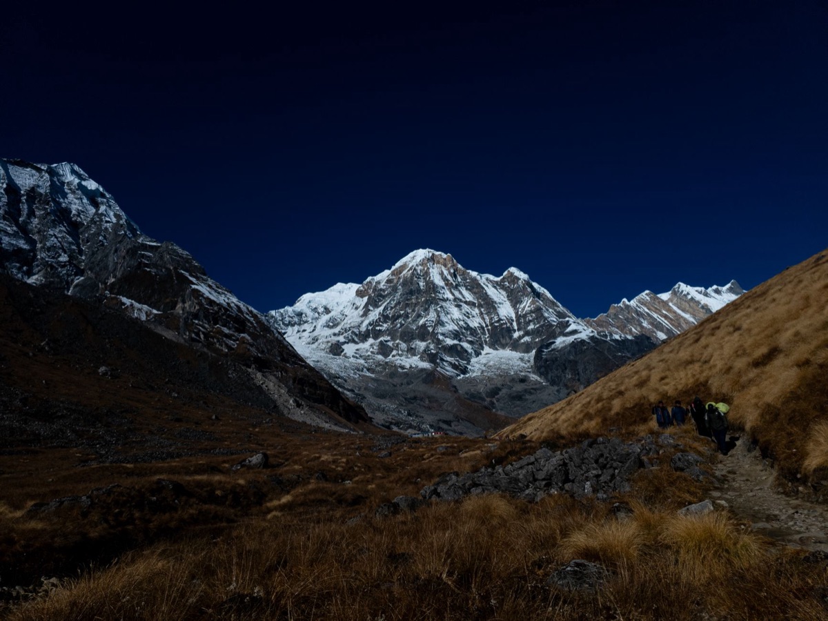 Snow-capped mountain range with hiking path