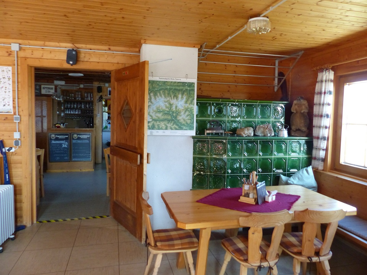 Interior of an alpine hütte with wooden tables and chairs