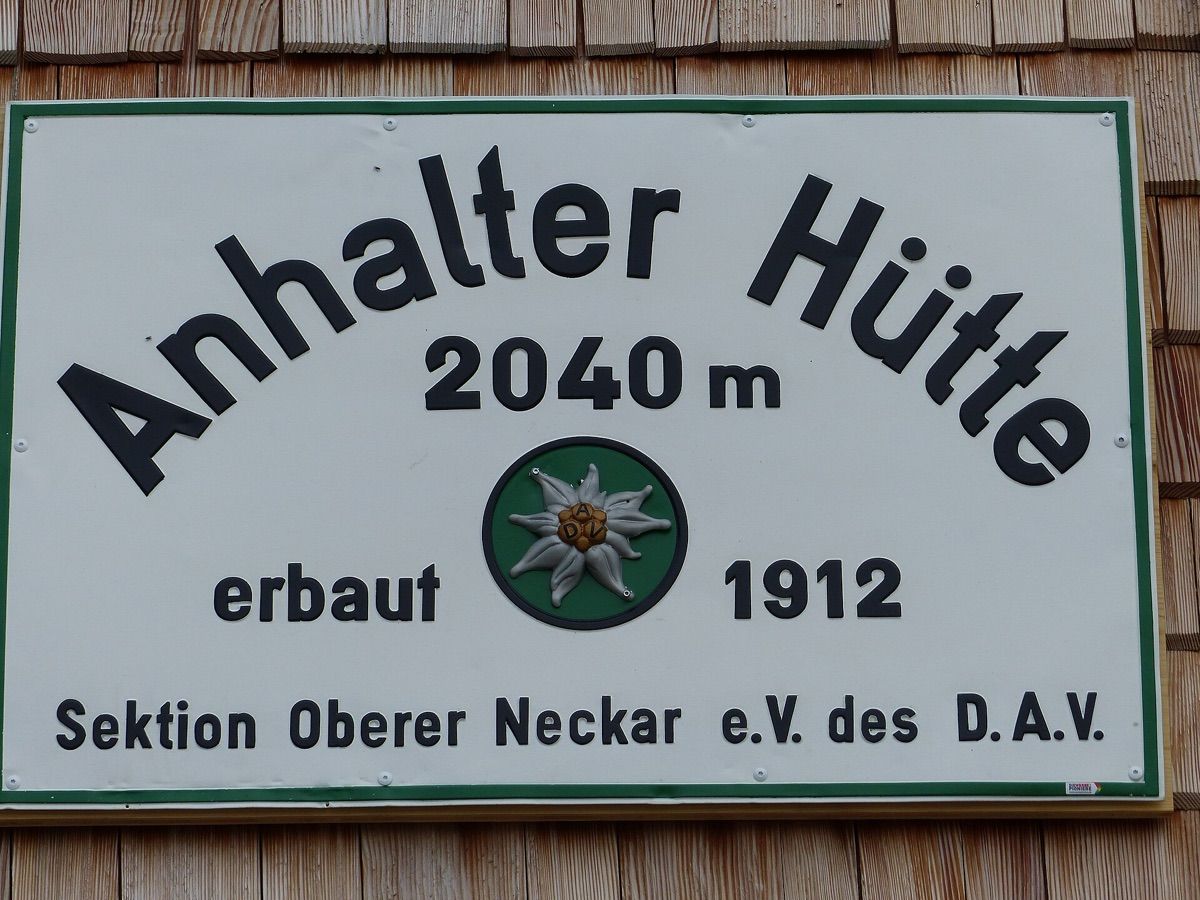 Sign outside an alpine hütte with 'i love alps' in chalk paint
