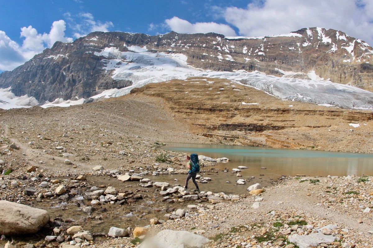 Hiker with backpack on alpine trail