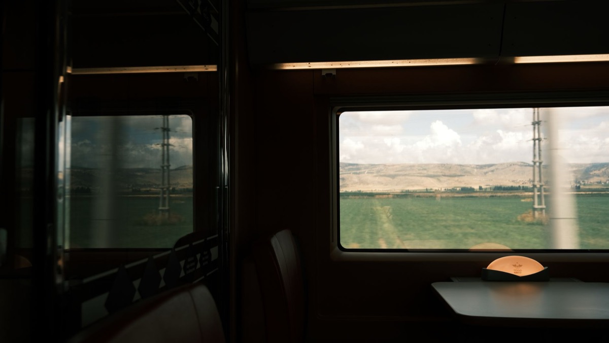 alpine train view from window with snow-covered mountains