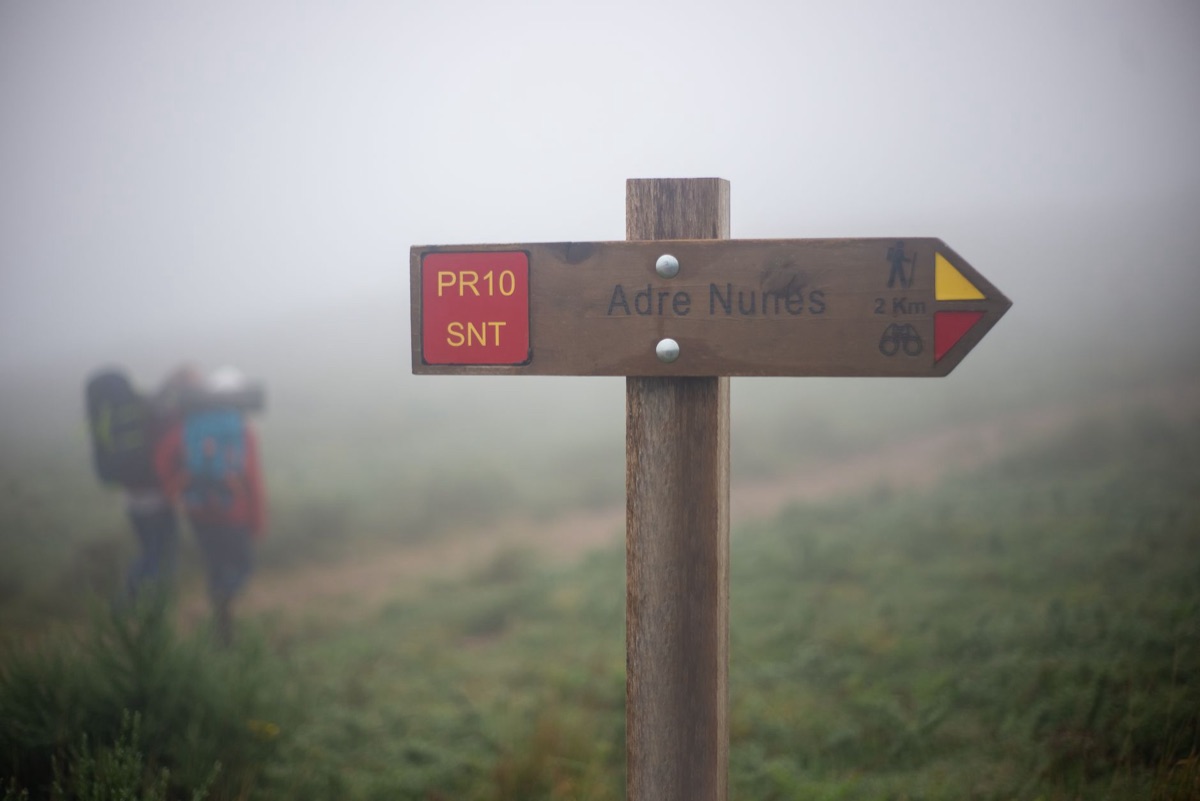 Hiking trail markers with difficulty and time labels