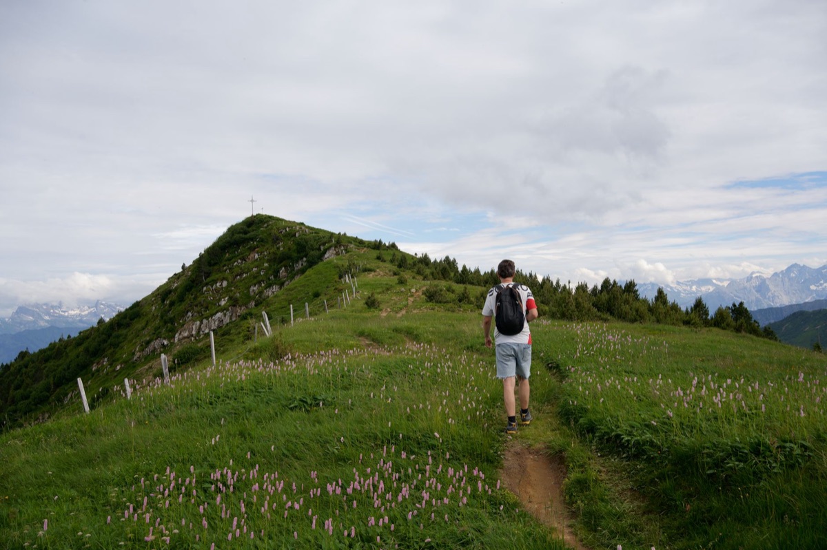 Hiker with map and compass on Alps trail